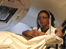 Nurse preparing a patient for radiation therapy